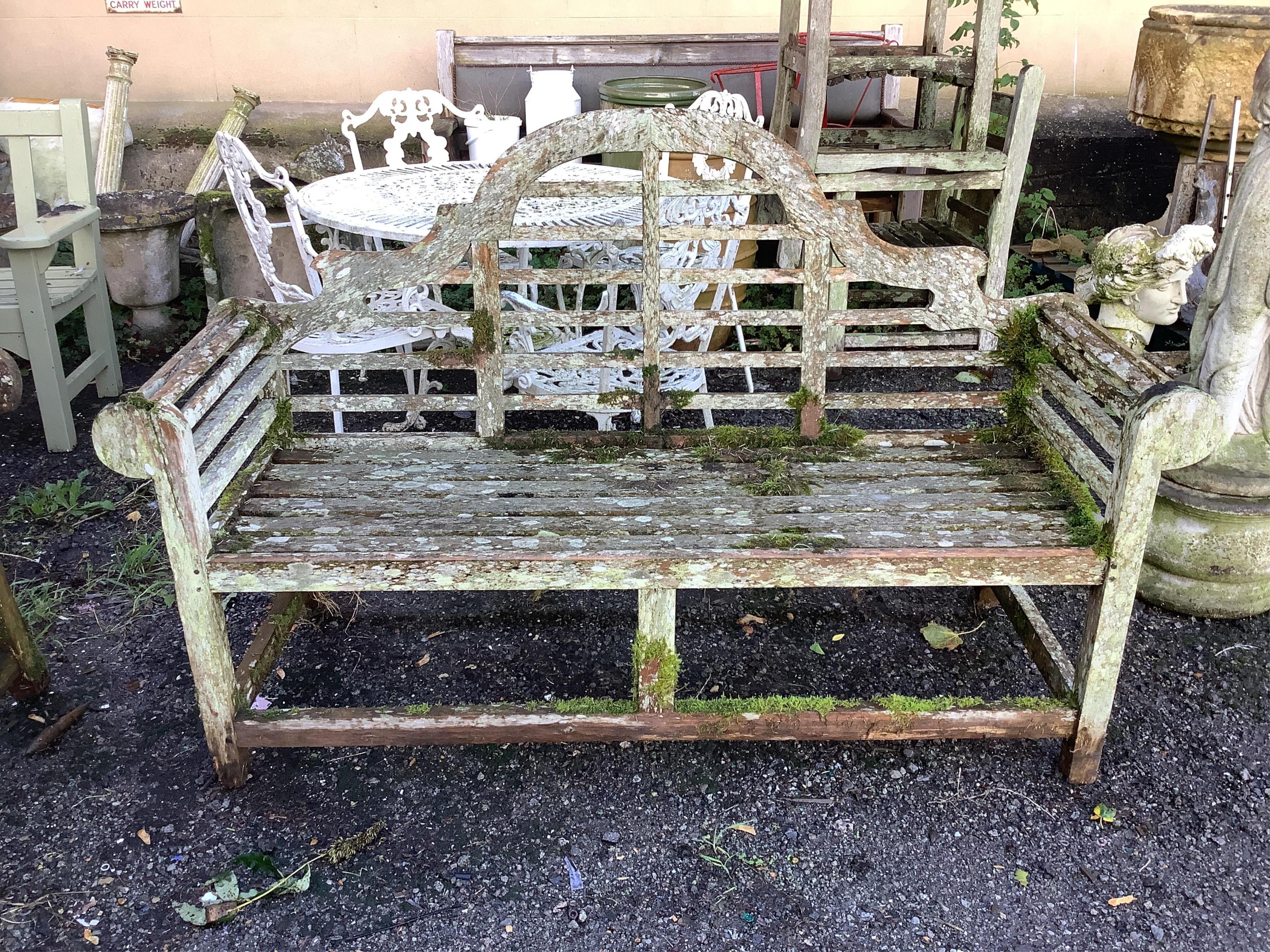 A weathered teak Lutyens style garden bench, width 165cm, depth 58cm, height 103cm. Condition - poor, covered in lichen